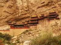 there is a temple hanging from the mountain...