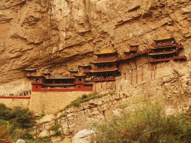 there is a temple hanging from the mountain...