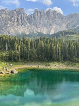 Emerald-colored Lake Carezza in Bolzano, Italy.