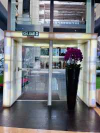 “Elegance in Motion: The Grand Lobby and Iconic Spiral Staircase of Hotel Maya KL”