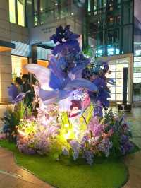 PURPLE FLOWERS AND GLOWING LIGHTS IN SHUNCHENG SHOPPING MALL