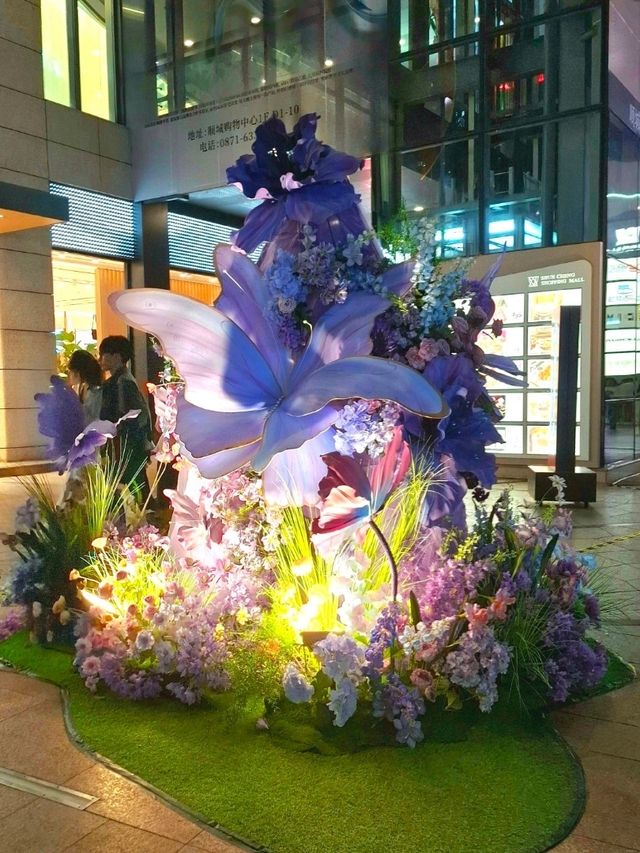 PURPLE FLOWERS AND GLOWING LIGHTS IN SHUNCHENG SHOPPING MALL