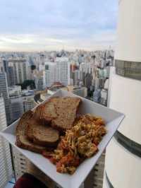 Try home made breakfast on top floor of iconic vintage building of copan with Sao Paulo skyline view