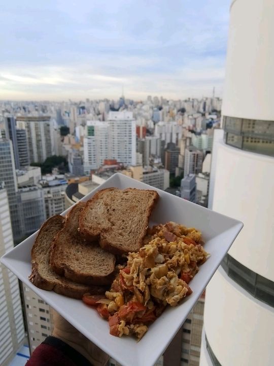 Try home made breakfast on top floor of iconic vintage building of copan with Sao Paulo skyline view
