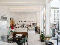 The café's minimalist white interior