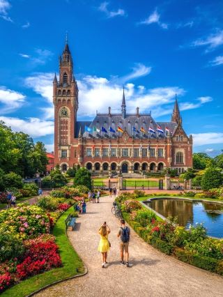 The Peace Palace, located in The Hague, Netherlands, is a globally renowned symbol of international justice and world peace. This magnificent building, constructed between 1907 and 1913, boasts an elegant and solemn exterior. Currently, it houses several legal institutions, including the International Court of Justice (ICJ) and the Court of Arbitration, and is a must-see landmark in The Hague. We recommend readers step into this century-old building and experience this sacred place so closely connected to global peace.

🗺️Recommended Itinerary: The Peace Palace is conveniently located at Carnegieplein 2, 2517 KJ Den Haag, within walking distance of the city center. It is open Wednesday to Sunday from 12:00 to 17:00 (closed Mondays and Tuesdays). It is advisable to plan your visit in advance and avoid Mondays and Tuesdays to avoid disappointment.

✨Must-Do Activities:

1. Exterior Photo: The main entrance and exterior walls of the palace are ornately designed, with sculptures seamlessly integrated into the gardens. We recommend taking panoramic photos of the palace from the entrance.

2. Garden Stroll: The lush gardens in front of the palace are refreshing and often seen with international tourists taking photos. 3. Information Center: Entering the "Peace Palace Visitor Center," you can learn about the history of world law, the architectural story of the Peace Palace, and interactive exhibitions, making it perfect for families and knowledgeable travelers.

4. World Peace Torch: Outside the palace stands the "World Peace Torch" monument, another famous must-see photo spot in The Hague.

📸Photo Spots

Peace Palace Main Entrance (tall stone pillars, exquisite architectural details)

Palace Gardens (full of European courtly style)

World Peace Torch (symbolic monument)

📝Travel Tips

1. It is recommended to check relevant tour activities on trip.com in advance, as there may be special exhibitions or guided tours on some days.

2. Most areas can only be photographed from the outside. The palace interior is only open to specific groups. Please check the official website and on-site signs.

3. It is recommended to bring rain gear, as the weather in the Netherlands is unpredictable. The outdoor gardens are better visited on sunny days.

4. It is recommended to arrive before 12:00 noon to avoid peak crowds and make it easier to take photos without people.

⚠️Important Notes

· Security is tight in the palace area; unauthorized entry and photography are prohibited.

· Conveniently located by tram or bus.

· English is the primary language, followed by Dutch. Some information centers offer Chinese introductions.

If you are interested in international law, historical architecture, and world peace issues, the Peace Palace is definitely worth including in your The Hague itinerary. Whether taking photos or exploring in depth, you'll experience a unique cultural atmosphere.

Topics: #TheHagueAttractions #PeacePalace #NetherlandsVisits #InternationalJustice #WorldPeace