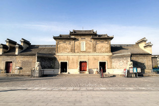 Blue bricks and black tiles reflect the setting sun, a courtyard that embodies the elegance of both the north and south
