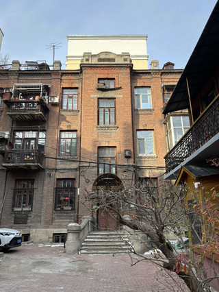 Step into Vintage Harbin on Central Street 🌃✨  
Harbin’s Central Street (Zhongyang Dajie) is the perfect backdrop for anyone seeking those old-world, nostalgic city vibes. Think European-style facades, playful stairwells with electric glow, and quaint corners that feel frozen in time—especially after dark! Start by wandering beneath the soft lamplight along this famous pedestrian street. Seek out a red-doored stairwell for your quintessential nighttime shot—my top photo spot (bonus if you catch a glimpse of retro posters in the frame).  

Don’t miss diving into the elegant old cafés tucked inside restored buildings. Some even welcome local feline residents! The combination of art-adorned walls, cats lounging on mismatched chairs, and soft indie music makes for a truly aesthetic, bohemian experience. Bring a sketchbook or camera; you’ll find endless inspiration here, from the vintage signs outside to the close-up details of modern architecture interwoven with Art Deco flourishes.  

Practical tip: Central Street is open all day, but late evening offers the most magical, cinematic feel (and fewer crowds to photobomb your stairwell and night light shots). Be sure to wear comfy shoes—the cobbled street and stairwells can be slippery, especially after rain or snow. For extra boho inspiration, step inside smaller galleries or independent boutiques hidden between bakeries and ice cream carts.  

Precaution: In winter, it gets icy—mind your steps, especially when searching for that perfect angle indoors or outdoors.  

#hellochristmas #CentralStreet #OldTownVibes #RetroChina #UrbanBohemian #RetroChina #harbin 