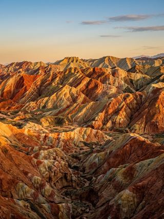 EP.7 Zhangye Danxia Landform – China

Let's fly together to marvel at the natural wonder of Zhangye Danxia Landform, also known as the "Rainbow Mountains," in Zhangye City, Gansu Province, China.
This world-class wonder is the result of the accumulation of sandstone and minerals over more than 24 million years, combined with tectonic plate movement and natural erosion, revealing vibrant, colorful streaks across the mountain range—red, yellow, orange, cream, and green—as if a world-class artist had painted them with a brush. Especially in the evening, when the sunlight strikes the mountains, the colors shine even more beautifully, creating an unforgettable scene.

#ZhangyeDanxia #ChinaTravel #RainbowMountains #UnseenNature #ChinaTravel #DanxiaValley

