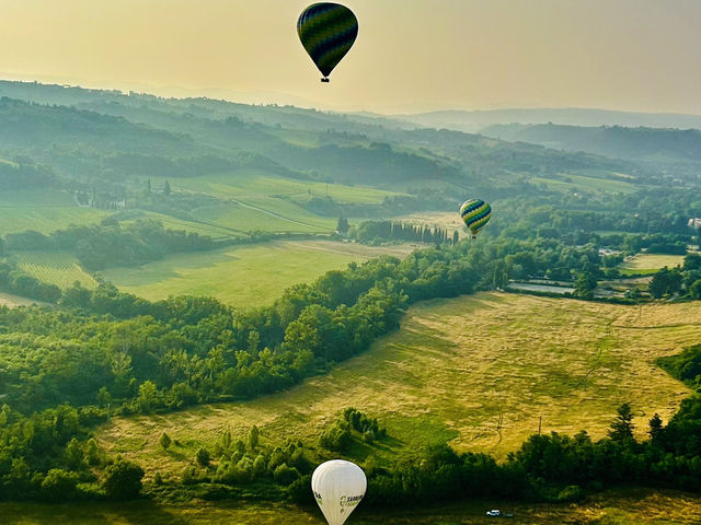 Hot air balloon ride above from Toscany sky 