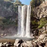 "Cheonjiyeon Waterfall: A Stunning View with a Rainbow on Jeju Island"