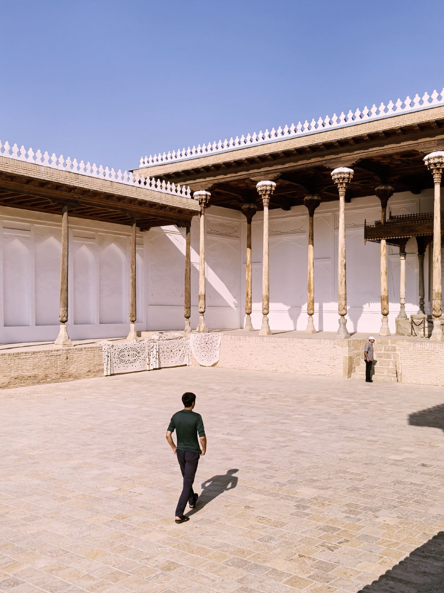 Took a break from the usual city wandering to check out some heavy-duty history in Bukhara. Ended up at the Ark Citadel and the Bolo-Hauz Mosque right across the square.

The Citadel is essentially a massive fortress made of mud and earth. The scale is impressive, though the inside feels a bit empty—mostly just standard museum displays. But walking up the ramparts for the old town view is definitely worth the ticket, especially when the evening sun hits the clay walls.

Right across the empty square is the Bolo-Hauz Mosque. Honestly, from a design perspective, I liked this one more. The twenty tall wooden pillars at the front have some really intricate carving. The contrast between the rough, brutalist feel of the fortress and the detailed woodwork of the mosque is the best part of this spot.

You don't need to spend half a day here. An hour and a half is plenty. Go late in the afternoon to avoid the heat. It’s a decent, quick stop before heading back to the quieter back alleys.