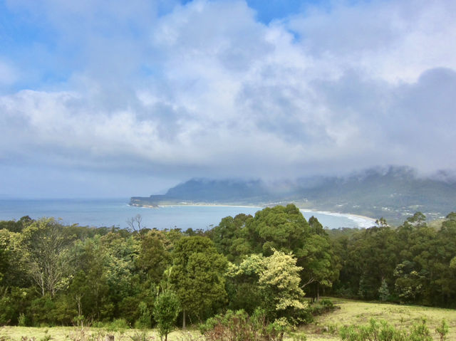 Cliffs, clouds, and colors: a rainbow at Tasman National Park Lookout