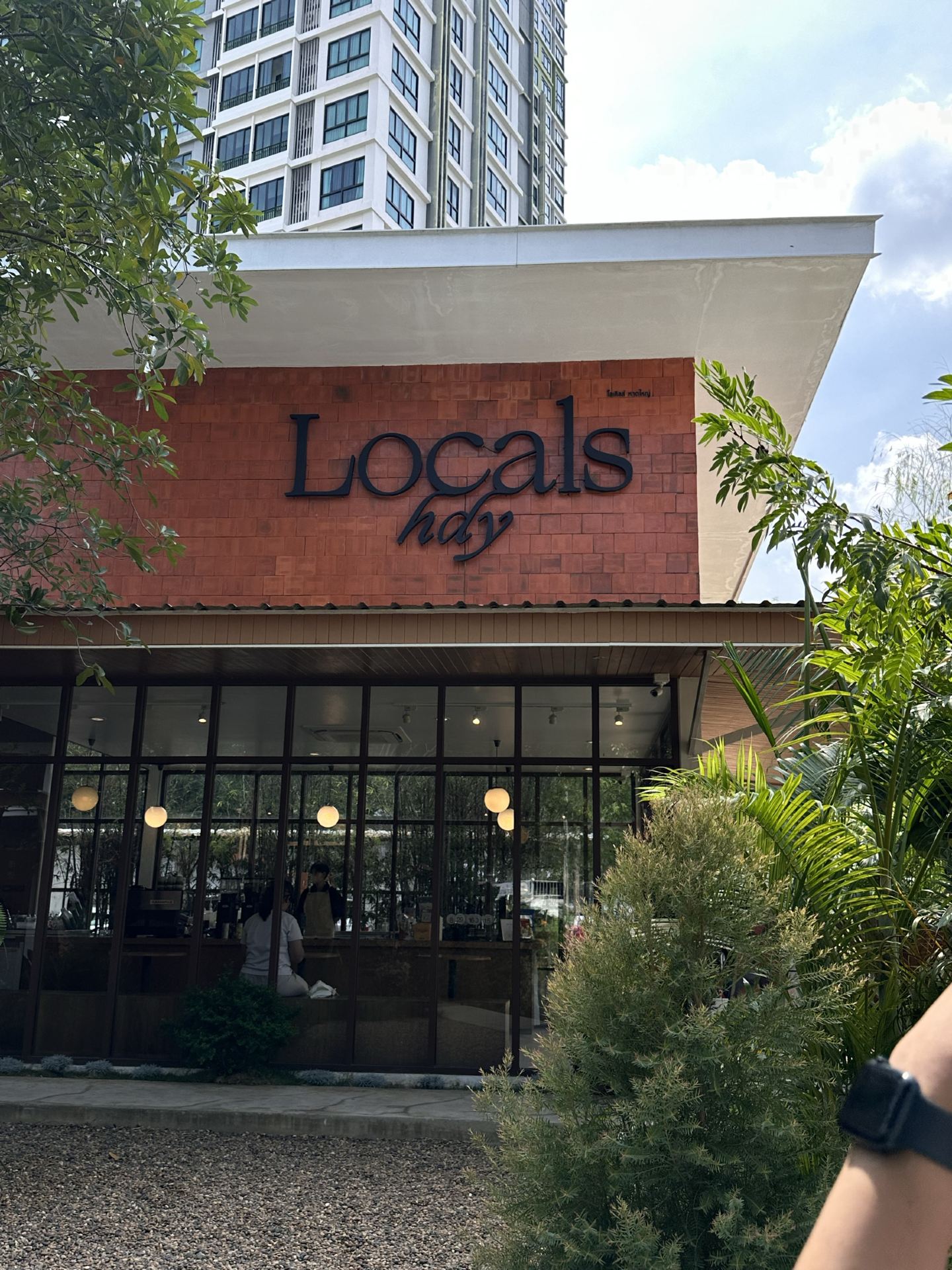 Locals.hdy · the exact brick-and-glass garden café in Hat Yai