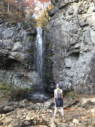 Autumn maples near a waterfall in Primorye