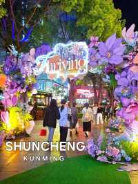 PURPLE FLOWERS AND GLOWING LIGHTS IN SHUNCHENG SHOPPING MALL