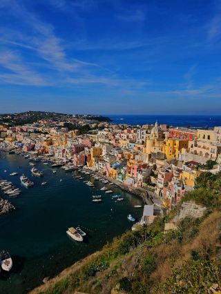 Procida is a hidden gem, bathed in sunlight and wrapped in sea breeze. Its pastel houses cascade gently toward the turquoise waters, creating a picture of perfect stillness. Here I stayed at the beautiful Hotel San Michele, where every morning felt like a soft beginning. Just around the corner, Gelateria Saint Rock served the most exquisite gelato I've ever tasted — creamy, rich, unforgettable. In the evening, I had dinner at Il Pescatore, a cozy restaurant by the sea, where I enjoyed fresh and perfectly cooked fish. Wandering through Terra Murata’s ancient charm and gazing at Marina Corricella’s colorful facades mirrored in the bay, I felt as though I had stepped into a painting. Procida is not just a place, but a feeling — of beauty, stillness, and stories whispered by the wind.