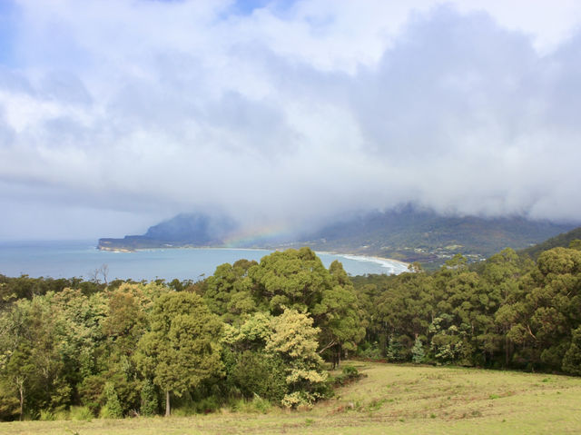 Cliffs, clouds, and colors: a rainbow at Tasman National Park Lookout