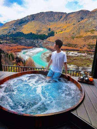 Stay in Queenstown valley, with a famous hot spring right outside
