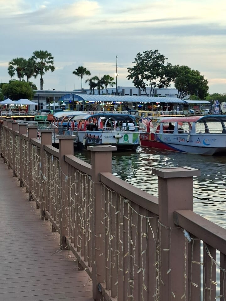 Melaka River Cruise — A Journey Through History, Culture & Heritage

Where History Flows with the River — Discover the Timeless Beauty of Melaka

Melaka, also known as Malacca, is one of Malaysia’s most fascinating historical cities. Located along the historic Strait of Malacca, this beautiful city has been shaped by centuries of trade, migration and cultural exchange between Asia and Europe. Today, Melaka is famous not only for its historic buildings and multicultural heritage but also for the charming Melaka River Cruise, which offers visitors a unique way to experience the city.

The Melaka River was once one of the most important lifelines of the city. For centuries, boats and traders used the river as an important route for transportation and commerce. As Melaka developed into a major trading port, the river became closely connected with the growth of the city. Even today, the river remains an important part of Melaka’s identity and heritage.

A River Surrounded by History

A ride on the Melaka River Cruise is much more than a simple boat trip. The approximately 45-minute cruise allows visitors to enjoy the city from a different perspective, passing historic bridges, old buildings, riverside restaurants, traditional villages and beautifully decorated riverbanks. Among the landmarks along the route are Kampung Jawa Bridge, Tan Kim Seng Bridge, Stadthuys, Jonker Street and Kampung Morten.

The riverbanks beautifully combine old and new Melaka. Traditional architecture stands alongside modern cafés, restaurants, colourful lights and tourist attractions, creating a unique atmosphere that reflects the city’s evolving character.

A Multicultural Heritage

Melaka’s greatest treasure is perhaps its multicultural identity. For more than 500 years, the city has been a meeting point for different peoples and cultures. Malay, Chinese, Indian and European influences have all contributed to Melaka’s unique traditions, architecture, food, languages, religious heritage and everyday life. UNESCO recognizes this multicultural character as an important part of the city’s Outstanding Universal Value.

One of the most fascinating cultural traditions of Melaka is Peranakan or Baba-Nyonya culture, which reflects a distinctive blending of Chinese and Malay traditions along with other influences. This heritage can be seen in traditional clothing, architecture, customs and especially in Melaka’s famous cuisine.

A UNESCO World Heritage City

In 2008, Melaka and George Town were inscribed together as a UNESCO World Heritage Site under the title Historic Cities of the Straits of Malacca. UNESCO recognizes these cities for their exceptional multicultural heritage and for the evidence of centuries of interaction between East and West.

Walking or cruising through Melaka feels like travelling through different chapters of history. Portuguese, Dutch and British influences can still be seen in many buildings and urban spaces, while Malay, Chinese, Indian and other Asian traditions remain an essential part of the city’s living culture.

Why Melaka River Cruise Is Special

The beauty of the Melaka River becomes especially magical in the late afternoon and evening. As the daylight fades and the riverside lights begin to glow, the reflections on the water create a peaceful and romantic atmosphere.

The boat in these photographs captures the essence of modern Melaka—tourism, culture, heritage and sustainable transportation coming together on one historic river. The surrounding greenery, riverside cafés, traditional structures and colourful boats make this area a wonderful destination for photography and sightseeing.

For travellers visiting Melaka, a river cruise is an excellent way to relax while discovering the history of the city. It provides a different view of famous landmarks and allows visitors to appreciate how the river has remained connected to Melaka’s past and present.

Melaka is more than a destination—it is a living story of cultures, people, trade and history. And along the Melaka River, that story continues to flow.

📍 Location: Melaka River, Melaka, Malaysia
🚤 Experience: Melaka River Cruise
🏛️ Heritage: UNESCO World Heritage Site
🌏 Known for: History, multicultural heritage, architecture, food and riverfront tourism

Melaka River — where every wave carries a story from the past, and every journey creates a new memory.