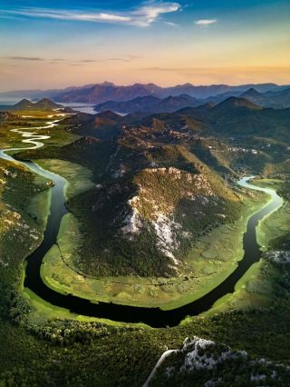 Skadar Lake, Montenegro 🇲🇪 — More to Explore

Skadar Lake is much more than a beautiful lake—it’s a huge wetland ecosystem, bird sanctuary, and cultural landscape stretching across Montenegro and Albania. The Montenegrin side is especially popular for its dramatic mountain scenery and traditional villages.

🏔️ What makes it special

· It is the largest lake in Southern Europe.
· The lake changes dramatically with the seasons; its water level can rise and fall significantly.
· Hundreds of bird species can be found around the wetlands, making it a paradise for birdwatchers.
· In summer, large areas of the lake can be covered with water lilies, creating an incredible landscape.
· The surrounding mountains plunge toward the water, giving the lake a distinctive fjord-like appearance in some places.

🚤 Best experiences

Virpazar
The most popular gateway to the lake. From here, you can take traditional wooden boats through narrow channels surrounded by reeds and water lilies.

Pavlova Strana Viewpoint 📸
One of the most iconic viewpoints in Montenegro. The road and river bend create a spectacular horseshoe-shaped landscape surrounded by mountains.

Rijeka Crnojevića
A tiny historic settlement beside the lake, famous for its old stone bridge and peaceful riverside setting.

Lake Skadar National Park 🌿
Much of the Montenegrin side is protected as a national park, preserving wetlands, forests, islands, and wildlife.

Karuč
A tiny traditional fishing village on the western shore, perfect if you’re looking for a quieter and less touristy side of the lake.

🌅 Best time to visit

May–June: lush greenery, pleasant temperatures and abundant water lilies.
July–August: warm weather and ideal conditions for swimming and boat trips, but more visitors.
September–October: quieter atmosphere, beautiful golden landscapes and excellent photography.

📍 Location

Montenegro & Albania
The most scenic and accessible areas for visitors are generally on the Montenegrin side, around Virpazar, Rijeka Crnojevića and Cetinje.
