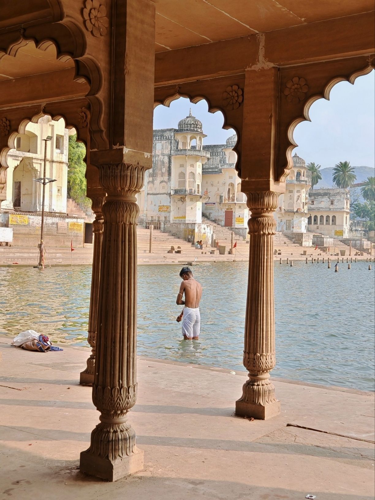 Planning or Spontaneity

When we were planning our trip to India, we didn't account for a holiday that shuts down the entire center of Delhi. We found out at the last minute and suddenly changed our plans, going to Jaipur because of it. That gave us a small window, and we decided to visit the city of Pushkar.

It's a holy city with a sacred lake in the center. Nowhere have I seen so many homeless cows and such an abundance of colorful historic buildings in one place. I literally didn't want to put my phone down during the walk. I have a million photos from every corner of the lake. There are a huge number of temples around, and people were carrying flowers in the first half of the day and lowering them into the lake. I was told it's a sacred ritual. After that, they performed ablutions in it. Around it there are tons of shops, including ones with fixed prices, which made us very happy. The outfit I was wearing was bought in this very city.

15th-century pavilions, old houses, temples, children studying to become servants of the sacred. This city is as colorful as it gets. After lunch there was no one there, so we walked around absolutely peacefully and no one bothered us while we were on the shore, which is completely untypical for India. I'm incredibly glad our plans got disrupted and we still got to visit this city.

The only warning I have is about scammers. They can persistently give you flowers and say it's all absolutely free, but after you take them, they'll say they were sacred and need to be offered in a certain way, and for this ceremony you're already obligated to pay. Some guys working on the territory of the Brahma Temple, the largest temple in the city, tried to trick us like that, and one man on the lake shore shouted that if I don't want to take his flowers, I didn't respect his country or his culture. But after we said we had no money, he left. And watch your step carefully, because there are still a lot of cows living here :)

#planitorwingit 