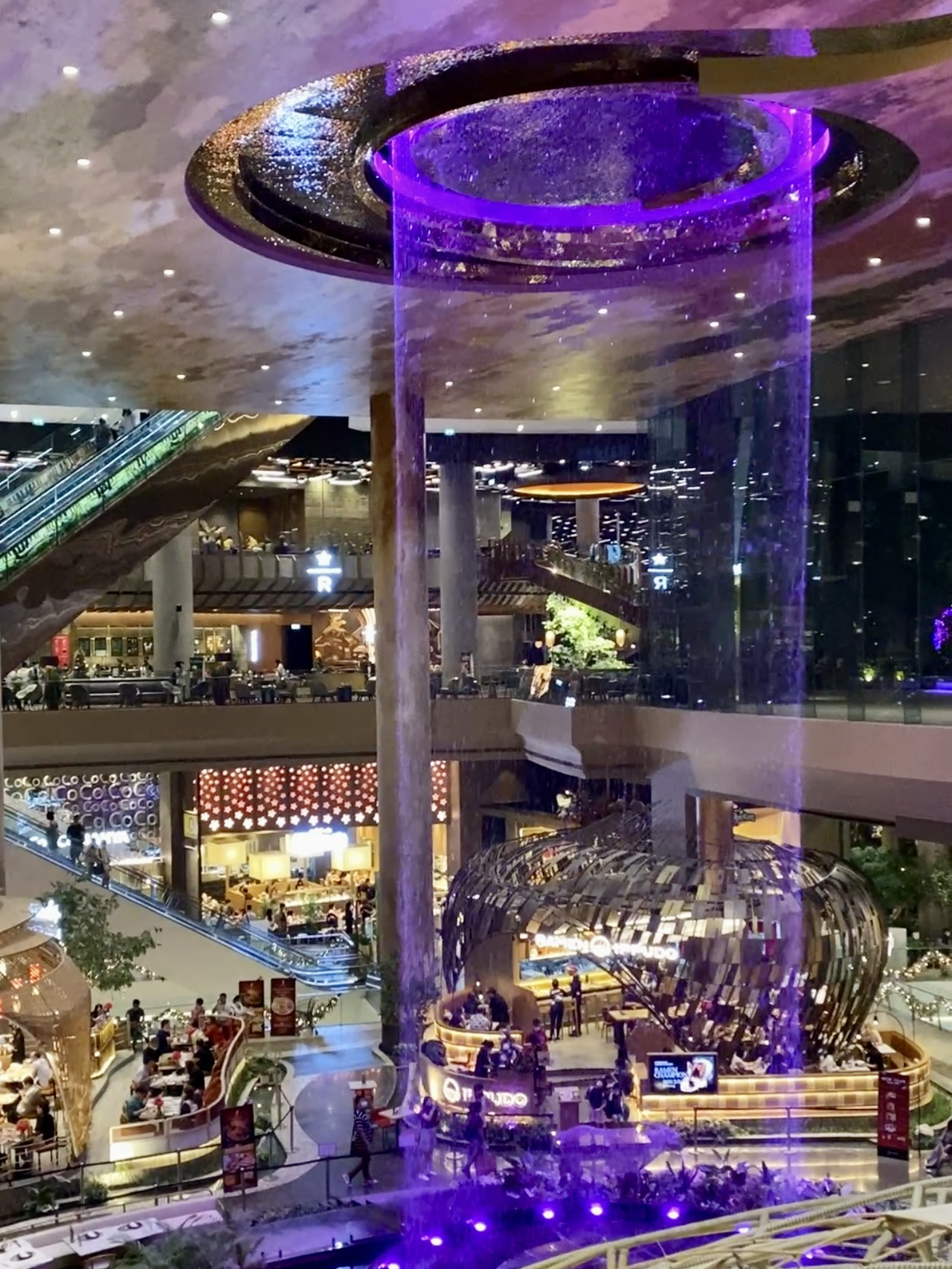 🤯It’s not just a massive shopping mall; it’s a full-on Bangkok landmark that draws even those who usually hate shopping. There are even guided tours dedicated to it!

Located right on the banks of the Chao Phraya River, ICONSIAM is considered one of the most beautiful and state-of-the-art malls in Thailand. Many people come specifically for the famous SookSiam food court, the evening fountain show, and panoramic restaurants with killer sunset views.

😋The main draw is the SookSiam zone on the ground floor. It’s like a "Mini Thailand" featuring floating markets, street food, traditional sweets, mango sticky rice, tom yum, seafood, pad thai, fresh coconuts, and dozens of local dishes at reasonable prices. ICONSIAM is the perfect spot to dive into local eats without any risk. It’s spotless, safe, and packs a massive variety of local cuisine right in one place.

🌆If you're a foodie, it's absolute heaven. ICONSIAM is home to a Starbucks Reserve, Japanese spots, Korean BBQ, premium steakhouses, dessert shops, and high-rise venues with epic views on the upper levels.

The vibe in the evening is truly magical—city lights reflecting off the river, music playing in the background, and tourists and locals gathering along the promenade to catch the night show.

🕶️But it's not all about the shopping. You’ll also find the massive ICON CINECONIC theater featuring IMAX and 4DX screens for an unforgettable movie experience.

⛲️Every evening along the promenade, you can catch the famous fountain show featuring music, lights, and lasers. It’s easily one of the best free shows in Bangkok (runs daily at 7:00 PM, 8:00 PM, and 9:00 PM).

Another major perk? The views. ICONSIAM is known as one of the best photo spots in Bangkok. Snapping pics on the riverside terrace, capturing the building's nighttime illumination, and framing the skyscraper skyline are huge hits. Many people visit just for the Instagrammable moments.

How do you get to ICONSIAM? The easiest way is to take the BTS Gold Line to Charoen Nakhon station. You can also hop on a riverboat—which is a mini-adventure in itself, offering gorgeous views of Bangkok. Taking a boat across the Chao Phraya River currently costs around 8–10 THB. Boats leave from Sathorn Pier, right by the BTS Saphan Taksin station. They run daily from 9:00 AM to 11:00 PM, and you can pay directly at the pier or as you board.

Pro tip: Try to get there after 4:00 PM. You can grab a relaxed bite and do some shopping during the day, then catch the river sunset and the fountain show in the evening. That’s when ICONSIAM is at its absolute best.

ICONSIAM is the place to experience modern Bangkok without the stress, heat, or chaos. Even if you don't plan on buying a thing, you’re guaranteed to leave with some amazing memories.

📍299 Charoen Nakhon 5 Alley, Khlong Ton Sai, Khlong San, Bangkok 10600, Thailand