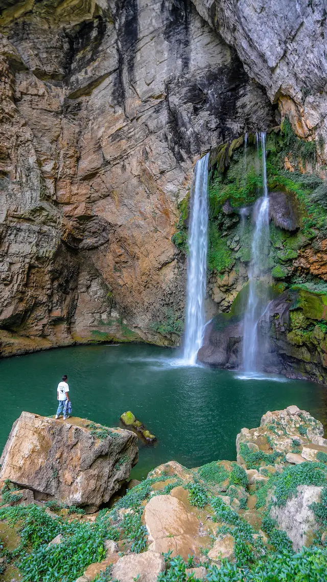 The Yangpi Cave Waterfall in Guizhou is a sight to behold, and the adjacent karst cave is also available for exploration