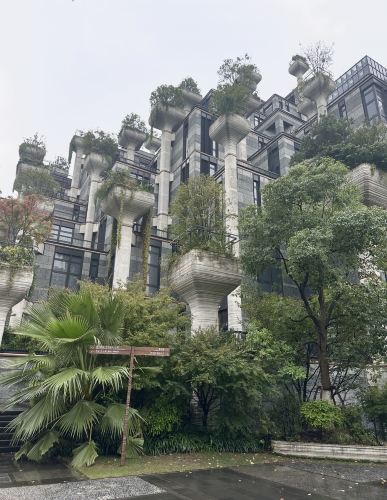 We visited 1000 Trees in Shanghai, and it was one of those places where the building itself becomes the main attraction. From outside, it looks like a stepped green mountain rising above Suzhou Creek: concrete columns, terraces, and trees growing at every level. The project was designed by Thomas Heatherwick’s studio and completed in 2021; its name comes from the more than 1,000 trees incorporated into the architecture.
But do not stop at the facade - the interior is just as interesting. Instead of a typical shopping-mall atmosphere, it feels like you are walking through a huge contemporary art space. Concrete columns continue through the building, greenery appears between the levels, and artworks, murals, and installations turn ordinary corridors and lifts into part of the experience. The complex was created next to Shanghai’s M50 art district, so the connection with street art and contemporary culture feels very intentional.
We wandered around the different floors, looked at the art, found a striking horse sculpture, and kept stopping to take photos of unexpected details. There are shops, cafés, restaurants, and terraces, but honestly, you can visit 1000 Trees even without a shopping plan - just for the architecture, the atmosphere, and a different view of Shanghai.
📍 1000 Trees (Tian An 1000 Trees), 600 Moganshan Road, Putuo District, Shanghai  
🚇 A short walk from Jiangning Road metro station; it is also close to the M50 Art District.
 #travel2026 #china #shanghai 