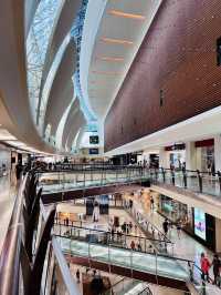“The Gardens Mall: A Modern Harmony of Glass, Wood, and Elegance”