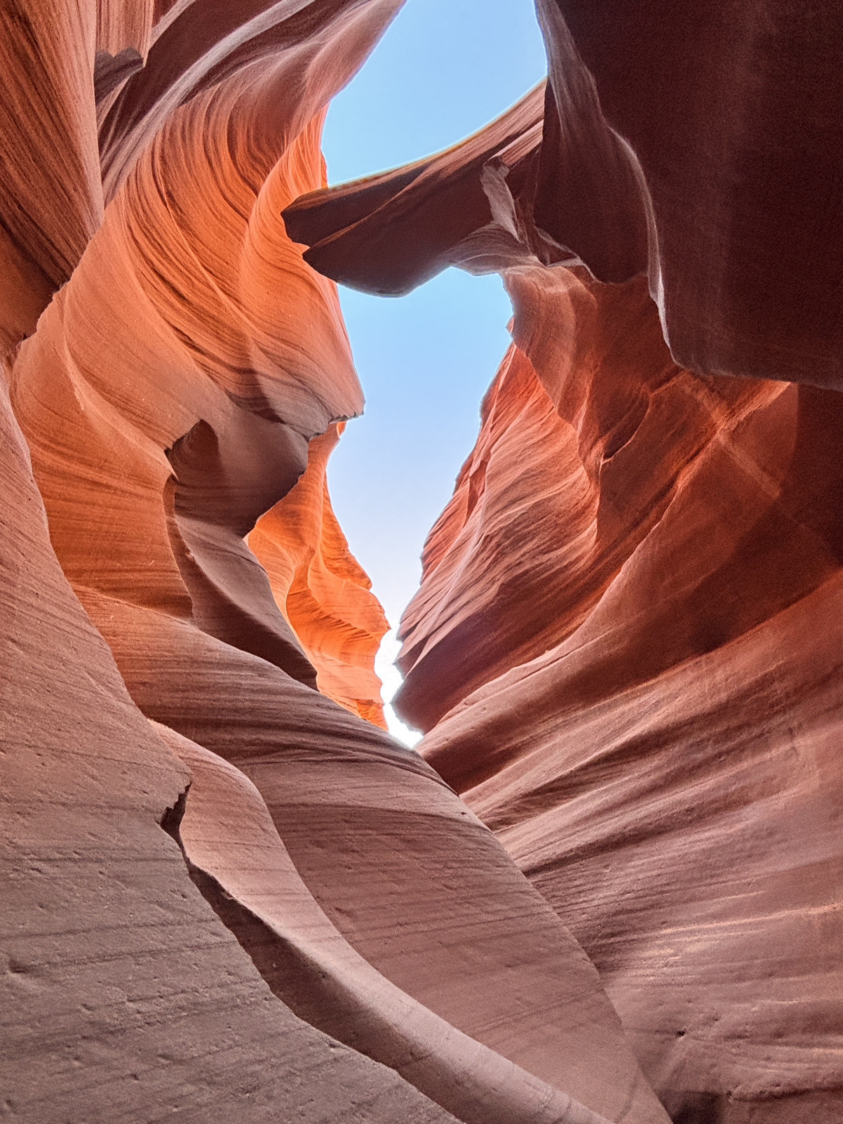 Visiting Antelope Canyon: Tour Prices, Upper vs. Lower, and What to Know Before You Go 1 Light beams streaming into Upper Antelope Canyon sandstone walls at midday