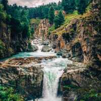 THE PICTURESQUE AHARBAL WATERFALL.