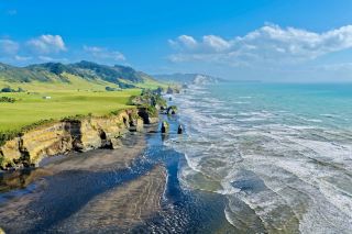 Three Sisters Rock Black Sand Beach | Step into a cinematic world at low tide.