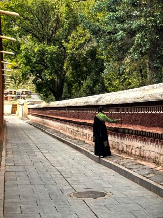 In the prayer wheel corridor of Labrang Monastery, seek the answer to healing your heart