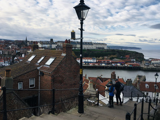 Strolling with the Little Dog Under the Lighthouse · Whitby, England