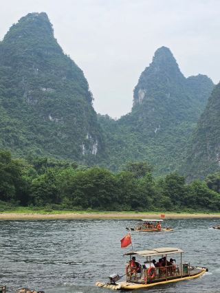 Get Lost in the Timeless Charm of Xingping Ancient Town 🍃🏮✨

Step back in time at Xingping Ancient Town—a riverside gem nestled amid the famous Karst peaks of Yangshuo. From cobbled alleys lined with Qing-era buildings to mesmerizing views that inspire classic Chinese art, this spot is pure magic for culture lovers and photographers alike!

Start your journey early, entering via No. 23, Rongtan Street. Meander through the old stone streets and soak up authentic village vibes—don’t rush! Must-do experiences include: hopping on a bamboo raft for surreal Li River views (the famous “20 Yuan note” landscape is right here!), sampling local specialties at food stalls, and chatting with friendly shopkeepers for some real travel stories.

For “insta-worthy” moments, catch golden hour on the riverside, or snap the dreamy misty mountains from the viewing platform near the ferry dock. The ancient theater stage and any weathered wooden doors are perfect for iconic travel portraits.

Practical tip: Though Xingping never really closes (open all day, year round), arrive before 10 AM to beat the tour groups and enjoy peaceful exploration. Wear comfy walking shoes—those old cobbles are no joke! Weekdays are best if you want a quieter, more local feel.

Bring cash for snacks and small souvenirs, as mobile payment doesn’t always work in tiny shops. Keep an eye out for slippery stones after rain and remember—this area is photogenic even on misty days, so don’t let the weather stop you!

#Yangshuo  #XingpingAncientTown  #ChinaTravel  #HiddenGem  #LiRiver 