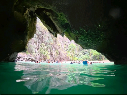 Swim through a cave to discover an emerald sea An 