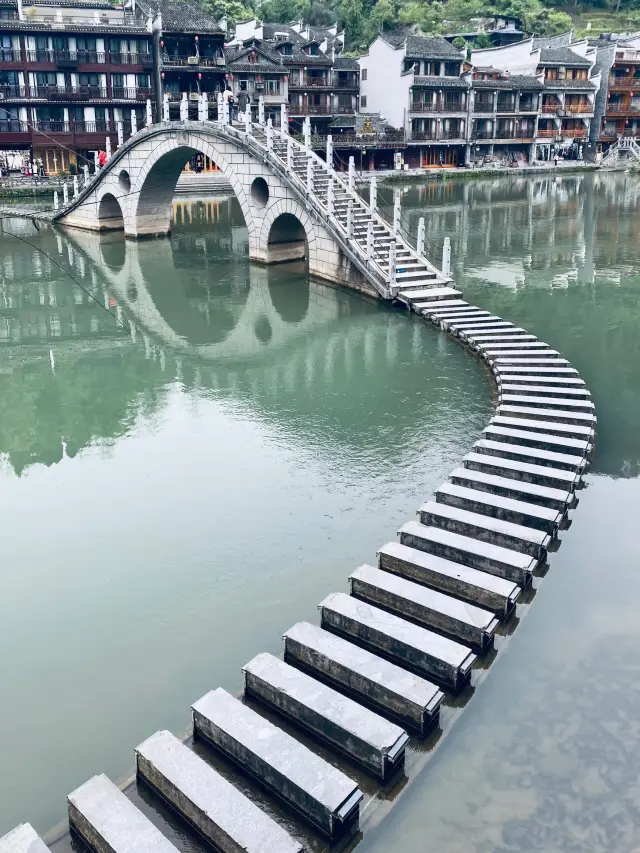 Check in at the popular tourist destination Fenghuang Ancient Town in Xiangxi, famous for its beautiful bridges