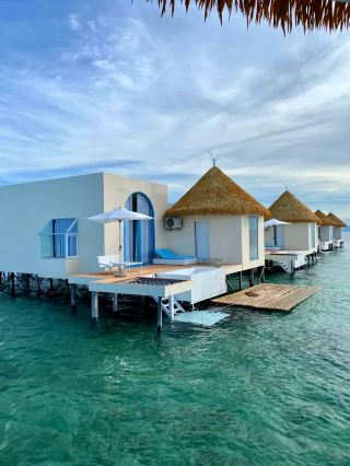 Besides Kapalai, which other water villa in Semporna is both beautiful and photogenic?
