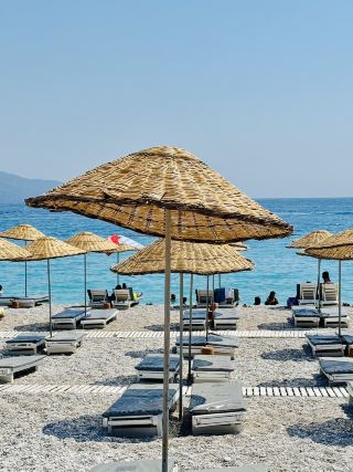 Ölüdeniz in Fethiye is truly a piece of paradise on Earth. The famous Blue Lagoon is even more stunning in person than in pictures. The water is an incredible shade of turquoise and is so calm and clear that it's perfect for a relaxing swim or paddleboarding.
For adventure seekers, paragliding from Babadağ Mountain is an absolute must. Soaring over the lagoon and the coastline is an unforgettable experience; the views are simply breathtaking. We also took a daily boat trip, which was a fantastic way to explore hidden coves and swim in the open sea.
In the evenings, the main promenade at Belcekız Beach comes alive with great restaurants and a relaxed, happy vibe. It can get quite crowded, especially during the peak summer season, but the place's sheer beauty more than makes up for it. Whether you want to relax on a stunning beach or seek adventure in the sky, Ölüdeniz has it all.