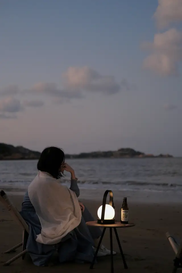 At sunset, the salty sea breeze blows towards the reefs and fishing village.