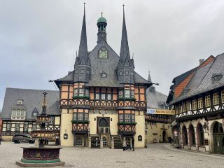Wernigerode is located in the northern foothills of the Harz Mountains in Saxony-Anhalt, Germany, about 90 kilometers from the state capital Magdeburg and about 35 kilometers from Goslar. It has a permanent population of approximately 33,000. The town's history dates back to the early 12th century, initially as the territory of the Counts of Wernigerode, gaining city status in 1229. After World War II, Wernigerode was incorporated into the German Democratic Republic (East Germany). After German reunification in 1990, it gradually developed into a renowned tourist destination in Germany, thanks to its well-preserved medieval cityscape, fairytale-like castle, and beautiful natural scenery of the Harz Mountains. Wernigerode Castle, originally built in the 12th century, has undergone several expansions and renovations, and now presents a Neo-Historicist style. The castle houses a museum showcasing local aristocratic life, historical artifacts, and art collections. Visitors can also climb to the top for panoramic views of the entire town and the surrounding Harz Mountains. Located in the city center, the town hall was built in the 15th century and is one of the finest half-timbered buildings in Germany. Its exquisite wooden facade, painted decorations and soaring spires are highly recognizable, making it the most representative landmark of Wernigerode and a classic example of German half-timbered architecture.