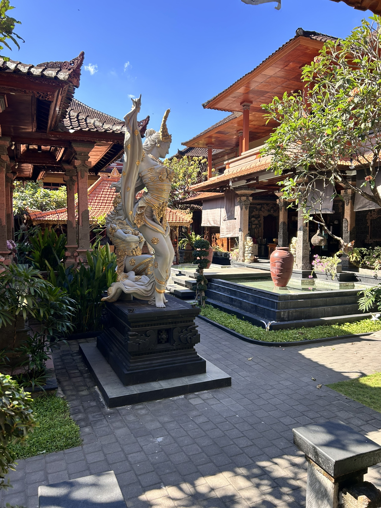 💰 Honestly, I still can't wrap my head around how you can get a hotel like this in Bali for such a low price.

🏨 Suka Beach Inn turned out to be an absolute hidden gem. The location is just perfect: right in the heart of the action in Kuta, surrounded by dozens of shops, restaurants, bars, and massage parlors. Plus, there's a massage place with those sweet "old" prices just a few steps from the hotel.

In all my travels to Bali, this is the first time I've come across such incredibly cheap accommodation. Honestly, it's my first budget trip ever 🙈 Despite the price, they cleaned the room, swapped out the towels, and changed the bed linens every single day. The staff was also super friendly and always ready to help.
The bathroom was fully stocked with all the essentials: shampoo, body wash, soap, toothbrushes, and toothpaste.

The only downside was the somewhat repetitive breakfast, though it was still tasty. It wasn’t a big deal, though, since there are plenty of cafes nearby serving up great food at reasonable prices. You can even book your stay without breakfast to save extra cash.

It’s about a 10-15 minute walk to 🏖️ Kuta or 🏖️ Legian beaches. The ocean here has great waves—an absolute paradise for surfers. The surfing prices were also a pleasant surprise 😳 And the sunsets? Absolutely stunning!
If you're looking for calmer waters to swim in, you can easily hop on a scooter to check out other beaches. By the way, you can rent a scooter directly from the hotel at a really good rate.

The property has a gorgeous, pristine pool, a traditional temple, and tons of lush tropical greenery, which was honestly the main reason we chose this hotel in Bali.

We booked a room here for our entire trip, which allowed us to leave our luggage behind while we took off for a few days to explore the rest of the island. It was the perfect setup for us 👍

All in all, it’s one of the best value-for-money places we’ve found in Bali—and honestly, on any of my trips anywhere ❤️🌴
