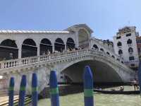 Rialto Bridge in Venice by land and boat