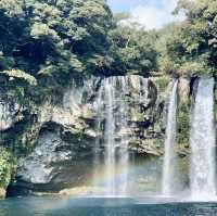 "Cheonjiyeon Waterfall: A Stunning View with a Rainbow on Jeju Island"