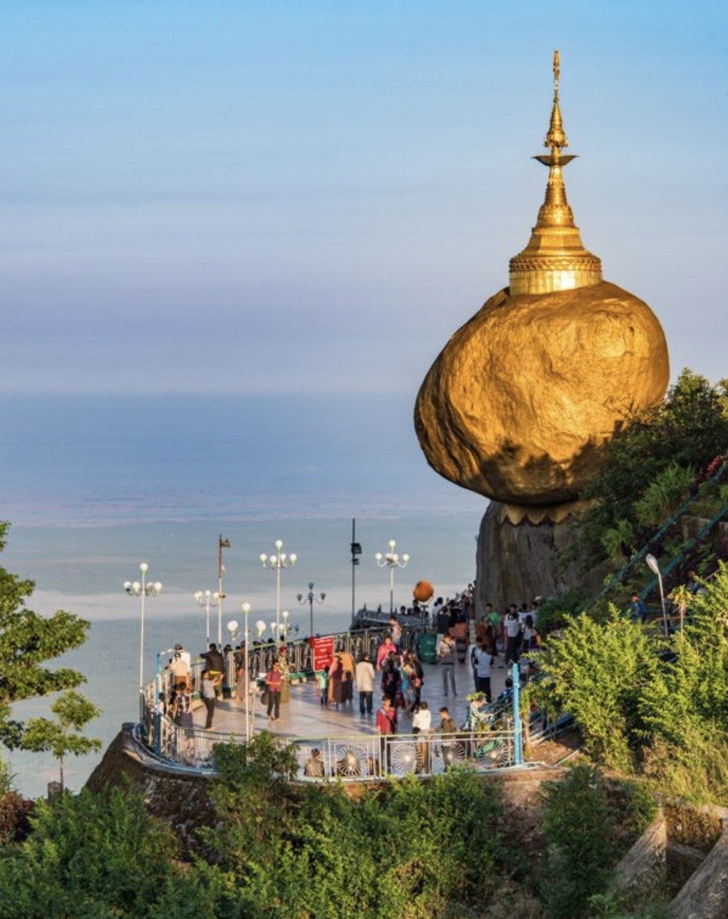 吉諦瑜佛塔(Kyaiktiyo Pagoda),又稱金岩佛塔,是緬甸最受尊崇、最受歡迎的佛教朝聖地之一,位於緬甸孟邦吉諦鎮的吉諦瑜山上。

🙏🏿 相傳,一位隱士將佛陀的三縷頭髮舍利供奉於此佛塔之中。

🙏🏿 這塊巨石高約7.6米,週長約15米,重達驚人的611.5噸。

🙏🏿 佛塔矗立在海拔約1100公尺(3600英尺)的懸崖邊,彷彿在挑戰地心引力。

🙏🏿 元旦是朝聖者的特殊日子,屆時佛塔平台將被9000支蠟燭點亮,並擺放水果、清水和焚香,以示對佛陀的虔誠供奉。

🙏🏿 如果您在週末或假日前來,有時朝聖者會在佛塔平台上露宿星空。

🙏🏿 朝聖季節:11月至隔年3月人潮湧動。

🕔 開放時間:上午5:00至晚上8:00

交通方式:火車、汽車

(i) 🚂 火車:

從仰光出發,前往吉諦瑜/吉諦瑜火車站:

火車行程約5小時。之後,您可以換乘巴士前往金蓬營地。

(二)🚓自駕:

從仰光出發,前往吉諦瑜/金蓬營地(大本營):車程約4~5小時。

私家車需停放在金蓬營地。之後,您需要換乘專用的重型四輪傳動卡車,該卡車獲準行駛在狹窄崎嶇、蜿蜒曲折的山路上,最終抵達隱士山巴士總站。

從這裡出發,您可以選擇以下方式登上佛塔:

🚡 纜車:10 分鐘 + 短程步行

▪️ 轎子(由四名挑夫肩扛,兩根竹竿支撐的敞篷木椅):約 30 分鐘

🚶➡️ 從隱士山步行:1 小時

🚶➡️ 從金蓬營地徒步:5-6 小時(請攜帶零食和水!)

🚶➡️ 如果您在徒步幾個小時後感到疲憊,您可以放鬆身心,欣賞沿途的自然風光,逛逛當地的紀念品商店,絕對值得一去!

▪️ 從塔頂可以俯瞰周圍孟邦山脈的壯麗全景。

▪️ 在雲霧繚繞的山頂欣賞日出日落,景色美不勝收。

▪️ 佛塔周圍有許多餐廳、各種商店和小吃攤。 💠 其他值得一去的地方:

⛰️ 標誌性的烏鴉嘴洞(喙洞)-一個傳說中向洞內投擲硬幣就能實現願望的地方。

💧 千萬別錯過吉耶克提約瀑布!這裡陰雨綿綿,水聲清冽,令人心曠神怡,彷彿置身於大自然的懷抱。

📍 旅行必備:

🦶 入口處有獅子守護,請赤腳進入。

🙍🏻♂️ 只有男性才能透過小橋觸摸金色的岩石並貼上金箔。

▪️ 地面濕滑,請穿防滑鞋。

▪️ 假日期間請提前預訂住宿,以免人潮擁擠。

📸 帶上相機,記錄壯麗的瀑布和懸崖景色!

▪️ 著裝得體,以示尊重。請遮蓋肩膀和膝蓋。避免穿著透視裝。

金岩 (Golden Rock) 充滿冒險氣息,流傳著史詩般的傳說,擁有令人嘆為觀止的自然美景,絕對值得攀登。