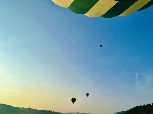 Hot air balloon ride above from Toscany sky 