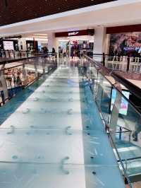 “The Gardens Mall: A Modern Harmony of Glass, Wood, and Elegance”