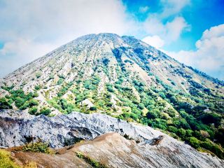 The Heart of the Volcano in Morning Mist: A Dance of Clouds and Sunrise