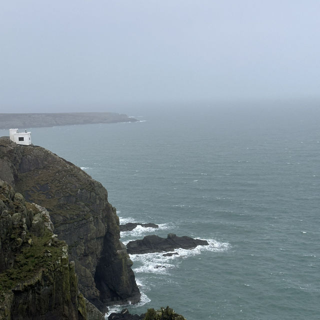 Windy hills on the shore with light house